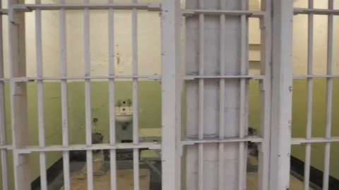 Locked prison jail gaol interior cell with iron bars prisoner incarceration  Stock Footage 121653646