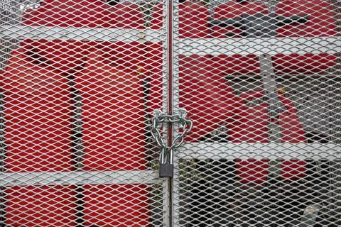 Locked Security Gate Protecting Red Gas Tanks Stock-Fotos
