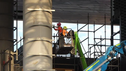 Locked off shot of construction workers in cherry picker working at height Stock Footage 332907634