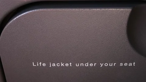 Locked shot of "life jacket under your seat" sign Video stock 152733275