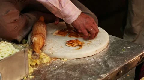 Locked-on shot of a man rolling a paratha 스톡 동영상 30125642