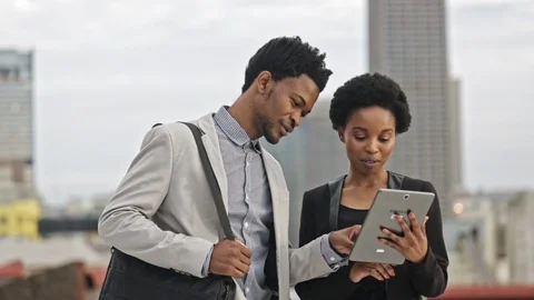Locked off shot of two people looking at a tablet Stock Footage 89294059