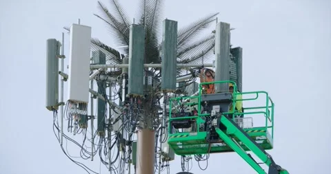 Locked Off Static Workers Installing a Cell Tower Stock Footage 250289019