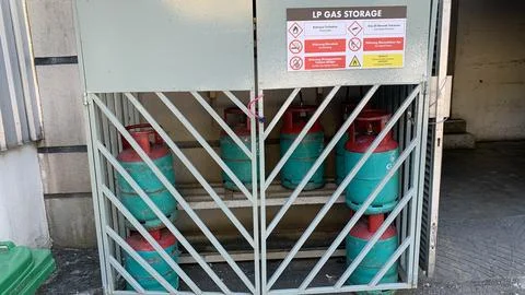 Locked storage cage containing multiple LPG gas cylinders Stock Photos