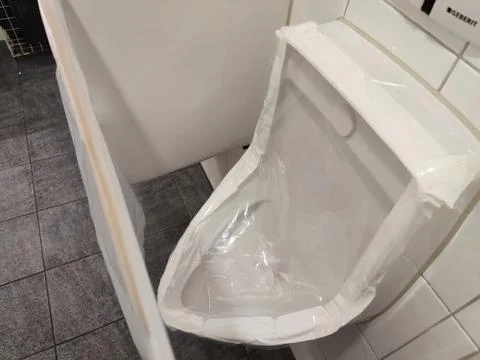 Locked urinal sealed with plastic. Stock Photos