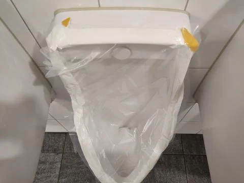Locked urinal sealed with plastic. 库存照片