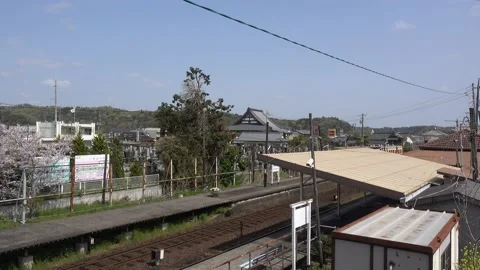 Locked off view of tiny train station in typical rural Japanese setting 動画素材 154047153