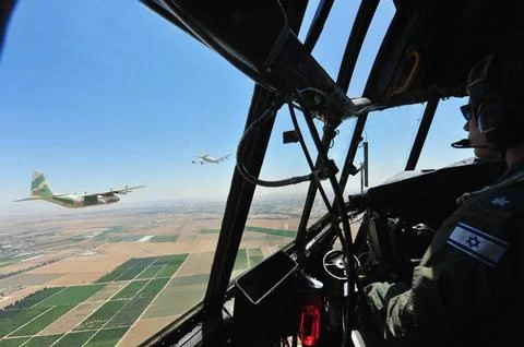 Lockheed C-130 Hercules fly above the Western Negev Israel Stock Photos