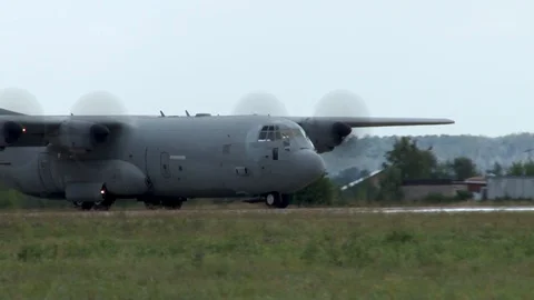 Lockheed C-130 Hercules, military transport aircraft taxis on runway. Closeup Stock Footage 115395127