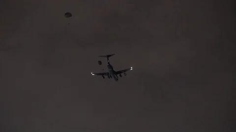 Lockheed C-5M Super Galaxy drops 2 parachute packages Video stock 113343682