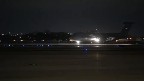 Lockheed C-5M Super Galaxy driving on the runway at night Stock Footage 113345986