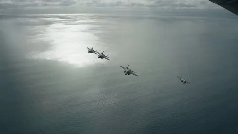 Lockheed Martin F-35 Lightning II 4 attack aircraft fly beautifully over the oce Stock Footage 121798424