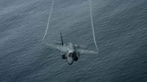 Lockheed Martin F-35 Lightning II Flies and Wings cuts air. Supersonic speed Stock Footage 121798549