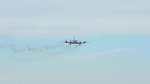 Lockheed P-3C Orion surveillance military aircraft arrival distant smoking smoke Stock Footage 144099262
