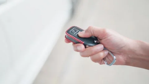 Locking and unlocking the car with the remote key When the car key button Stock Footage 264105795