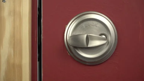 Locking and unlocking a deadbolt on an exterior door Stock Footage 194513019