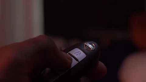 Locking and Unlocking a Nissan Keyfob Stock Footage 157942282