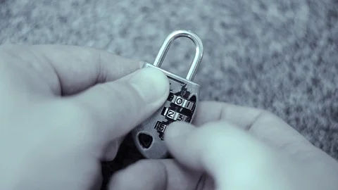 Locking and unlocking a numeric sequence padlock. Stock Footage 87612339