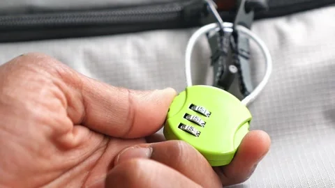 Locking a bag with a combination lock at the airport Stock Footage 342889916