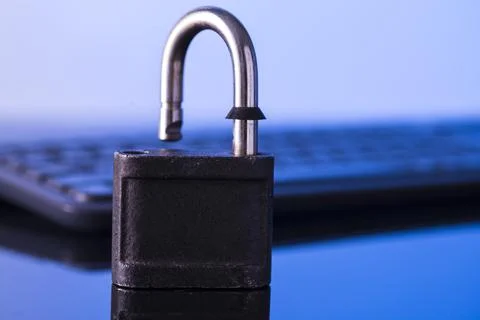 Locking the computer keyboard. The lock and keypad are tinted blue. Informati Stock Photos