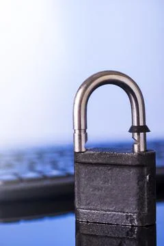 Locking the computer keyboard. The lock and keypad are tinted blue. Informati Stock Photos