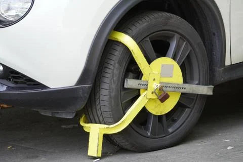 Locking device on the wheel of a car, parking violation in the city, city par Stock Photos