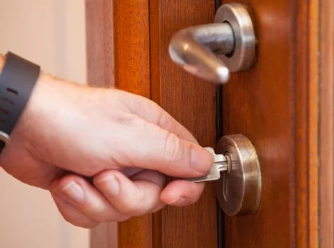 Locking the door with a key. Protect your house by locking the door. Stock Photos