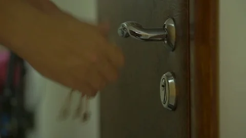 Locking up or unlocking door with key in hand Video stock 77481257