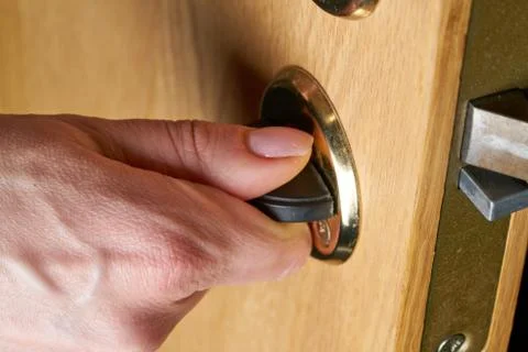 Locking up or unlocking door with key in hand Stock Photos