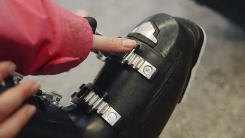 Locking ski boot buckles in changing room before going out for skiing activity Stock Footage 261761272