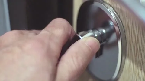 Locking, unlocking a deadbolt on a door. Stock Footage 96847145