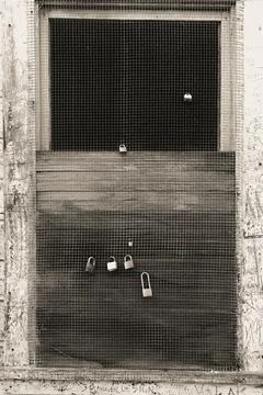 Locks attached to a screen door Stock Photos