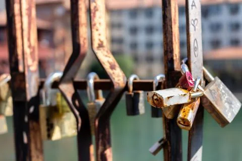 Locks closed on the railing of a bridge Stock Photos