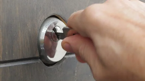Locks a door lock with a key Stock Footage 125769872