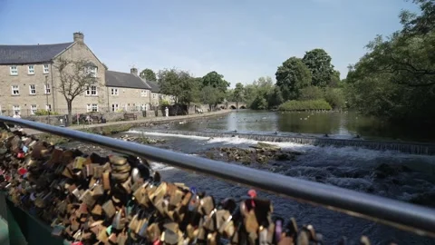 Locks on footbridge and River Wye, Bakewell, Derbyshire, England, United Kingdom Stock Footage 280276095