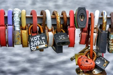 Locks hung on the railing of the bridge according to tradition on the wedding Stock Photos