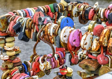 Locks hung on the railing of the bridge according to tradition on the wedding Stock Photos