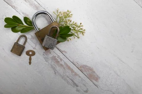 Locks latched with old key rustic neutral textured background Stock Photos