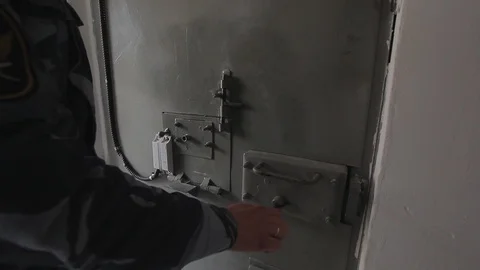 Locks the metal door of the prison cell Stock Footage 91779680