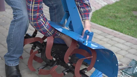 Locksmith assembles new tiller for walk-behind tractor 스톡 동영상 306441554