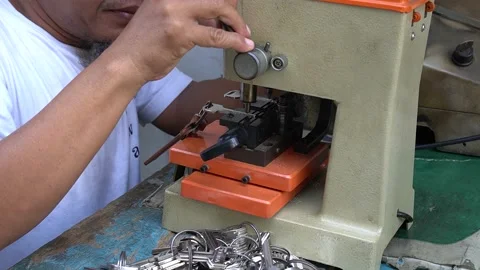 A locksmith create a duplicate of a door lock using a special tool in Jakarta Stock Footage 211577555