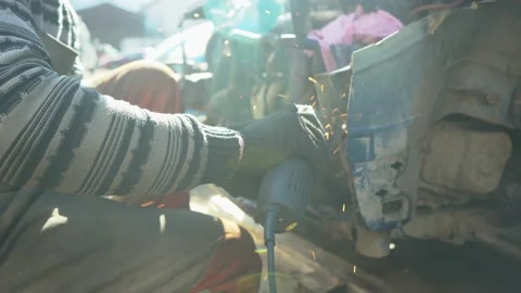 A locksmith cuts out a metal part of a car body with a tool.  Video stock 171869179