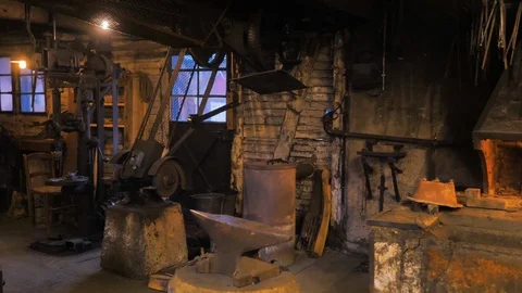 Locksmith with a fire burning in fireplace from the forge overview Stock Footage 124476780