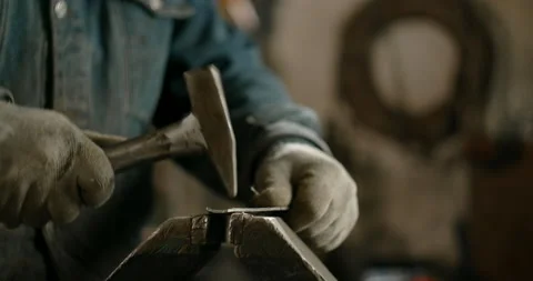 Locksmith hammers sheet metal, shaping metal manually, metalwork at workshop, 4k Stock Footage 151904033