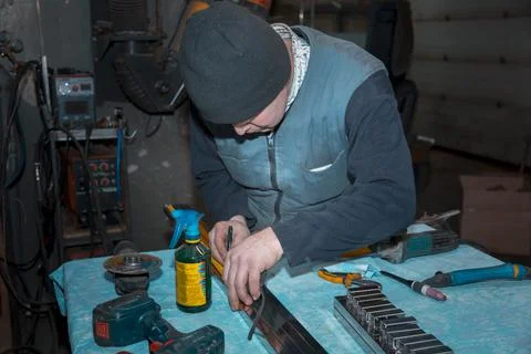 Locksmith installer marking out a stainless profile pipe 스톡 사진