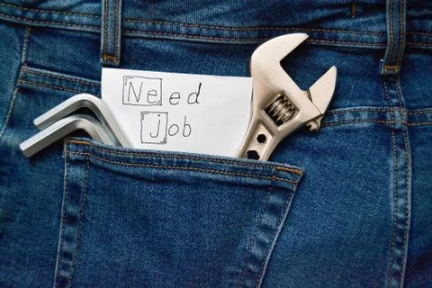 Locksmith key in jeans pocket, note with the inscription "Need a Job" Stock Photos