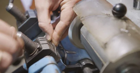 Locksmith makes a duplicate of the key lock. Close up. Stock Footage 94049463