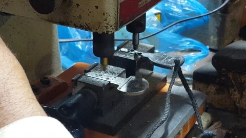 Locksmith making a copy of a metal key on his machine with his experties Stock Footage 119526149