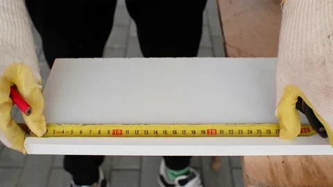 Locksmith marks a segment on the workpiece with a tape measure and a red pencil. Stock Footage 164156544