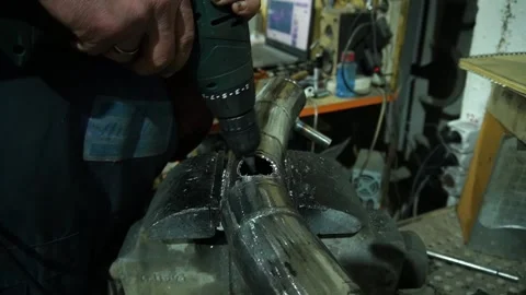 A locksmith performs metal drilling Stockbeeldmateriaal 235727399